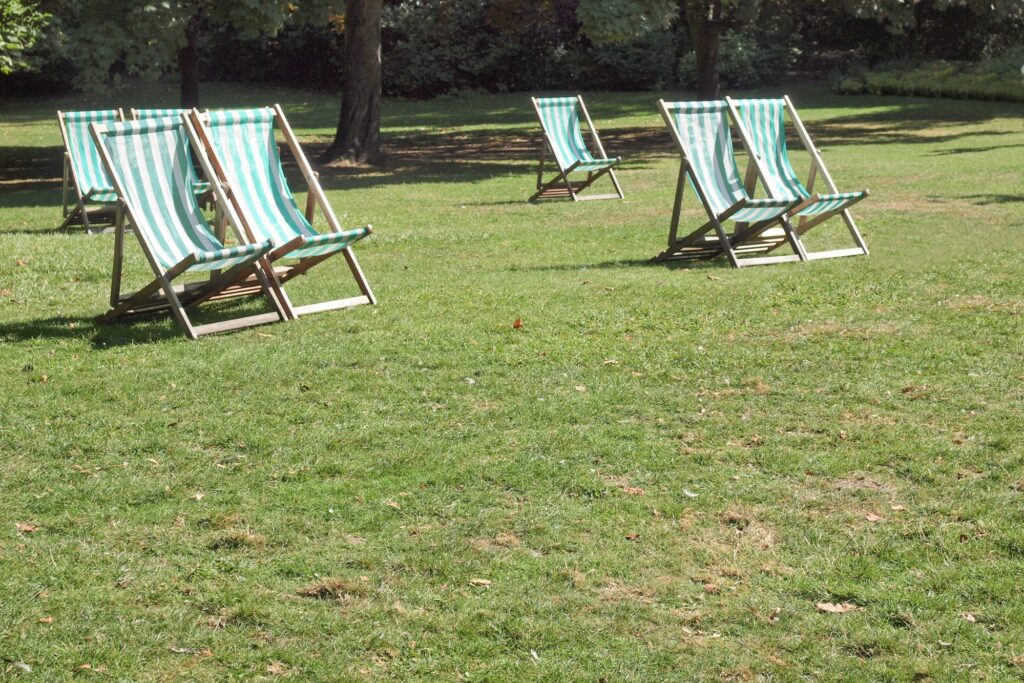 Deck chairs in a park in the concept of parks and green spaces in Twickenham.