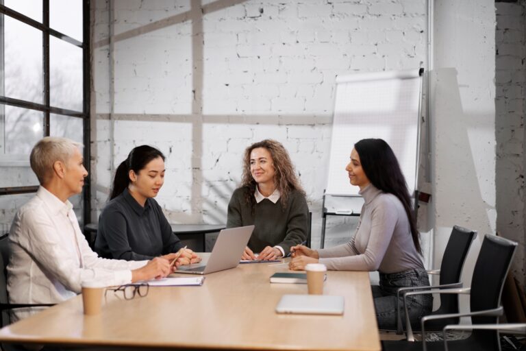 Colleagues talking about the office move in the concept of 'How to Inform Employees About an Office Move to Twickenham'.