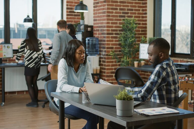 Employees in a busy office in the concept of 'How to Minimise Disruption During an Office Move to Twickenham'.